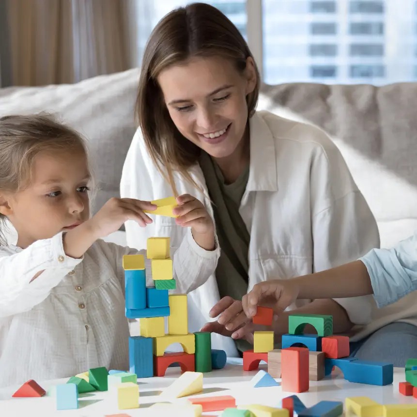 Caregiver and children playing with blocks